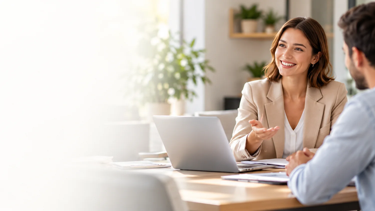 Financing specialist speaking with an applicant at a laptop